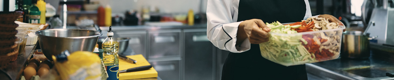 Chef in a galley preparing food for vessel crew 